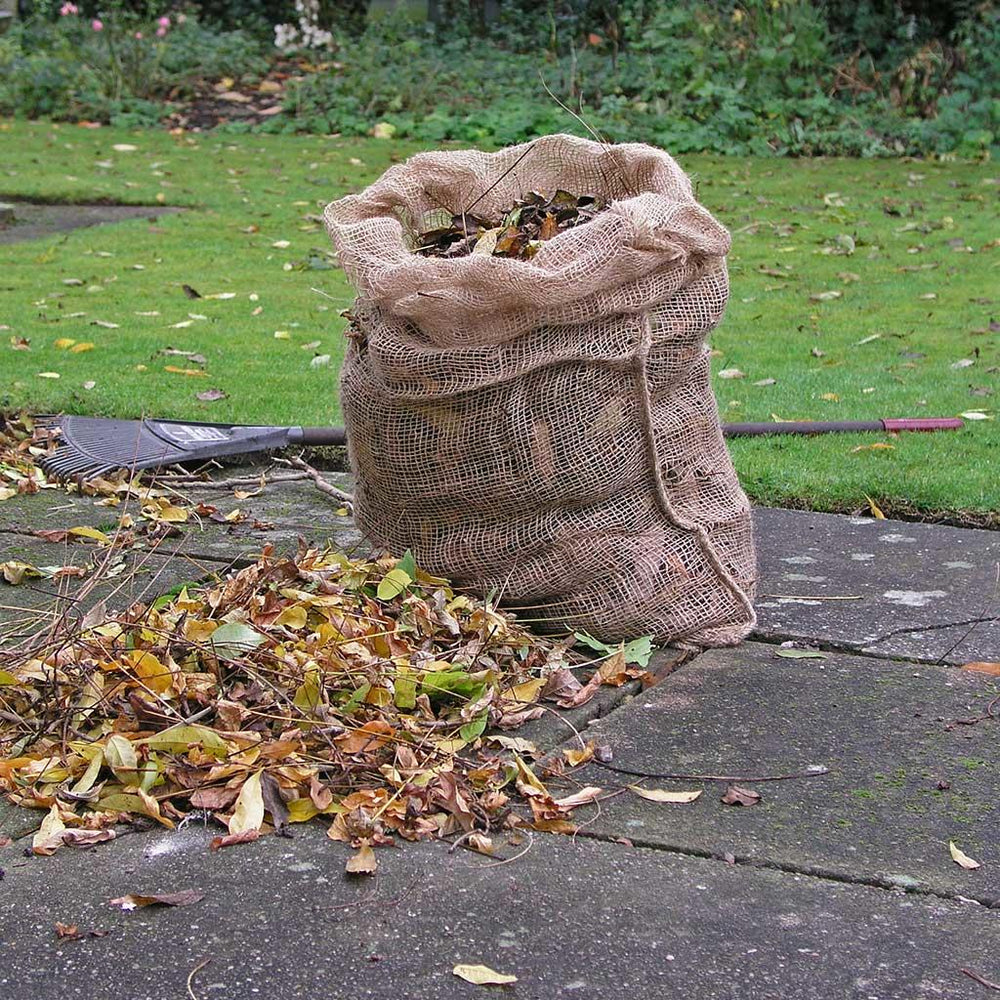 A jute back stuffed full of fallen leaves.